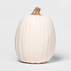 a white ceramic pumpkin with gold trim