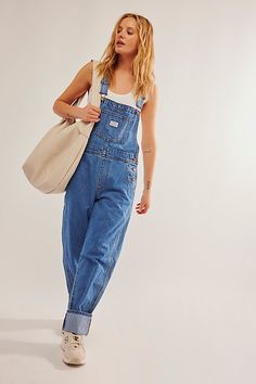 The perfect vintage-inspired overalls from Levi's, this distressed style is featured in a classic bib-and-brace silhouette with front pouch pocket and relaxed, straight leg design. * Adjustable straps * Four pocket design * Side button closures * Logo patch detail at front | Levi's Vintage Overalls at Free People in Medium Wash, Size: XL Cute Overall Outfits, Free People Overalls, Vintage Summer Outfits, Cute Overalls, Vintage Overalls, Overall Outfit, Overalls Outfit, Modest Summer Outfits, Summer Outfits For Teens