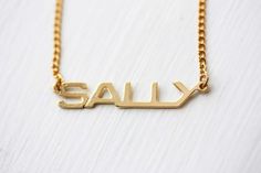 Sally Name Necklace, Sally Necklace, Name Jewelry Gold, Vintage Name Necklace, Name Plate Necklace, Retro Everyday Gold Jewelry, Vintage Nameplate Necklaces, Vintage Custom Name Jewelry Nameplate, Vintage Custom Name Nameplate Jewelry, Vintage Personalized Name Necklace For Anniversary, Vintage Custom Nameplate Jewelry, Personalized Vintage Name Necklace For Anniversary, Vintage Personalized Nameplate Necklace, Vintage Gold Name Necklace