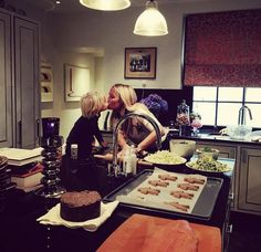 two women are making food in the kitchen