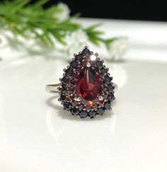 Vintage Sterling Silver Natural Dark Red Garnet Ring....Marked 925... Size 6...Total of weights 4.2grams...Measure of Face 17.6MM...It's in very good condition. Formal Red Pear-shaped Ruby Ring, Formal Pear-shaped Ruby Ring, Red Pear-shaped Ruby Ring, Classic Pear-shaped Red Rings, Classic Red Pear-shaped Rings, Pear-shaped Red Ruby Ring Gift, Gift Pear-shaped Red Ruby Ring, Red Pear-shaped Ring For Formal Occasions, Pear-shaped Red Rings For Formal Occasions