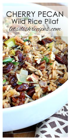 a white bowl filled with rice and raisins on top of a table cloth