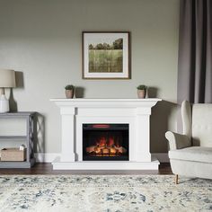 a living room with a fire place in the center and a painting on the wall