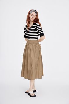 Details: Cotton blend long skirt in khaki High-rise Zip closure on side Side pockets Materials & Care: 95% Cotton, 5% Spandex Hand wash | Dry clean Do not bleach Size & Fit: Model is 5'7", Bust 32, Waist 24, Hips 35, wearing a size S Item #: UL2SK12 Khaki Flowy Skirt For Spring, Khaki Midi Skirt For Spring, Fall Long Khaki Skirt, Casual Voluminous Skirt For Workwear, Casual Workwear Voluminous Skirt, Relaxed Khaki Skirt For Spring, Relaxed Fit Khaki Skirt For Spring, Beige Cargo Skirt For Spring Workwear, Relaxed Khaki Skirt For Fall