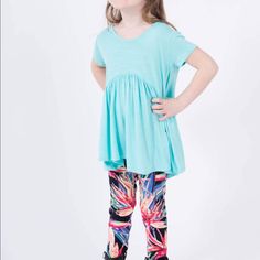 Made From Easy To Care For Rayon Spandex Knit, This Flattering And Fun Top Is Perfect With Your Favorite Kids Leggings Or Jeans. 95% Polyester 5% Spandex Arched Empire Waist. Gathered Peplum. Rounded Neckline Flattering 'Perfect Sleeve, Hip Grazing Hem Made In The Usa From Imported Materials New With Tags From Smoke And Pet Free Boutique. Sizes: Xxs - Child's 1-2 Xs - Child's 2-4 S - Child's 4-6 M - Child's 7-8 L - Child's 10-12 Xl - Child's 12-14 Summer Stretch Tops For Playtime, Playful Stretch Crew Neck Top, Playful Light Blue Tops For Loungewear, Light Blue Casual Tops For Playwear, Playful Stretch Tops For Playtime, Stretch Playful Tops For Playtime, Playful Fitted Blue Tops, Light Blue Tops For Playtime In Spring, Cute Light Blue Tops For Playwear