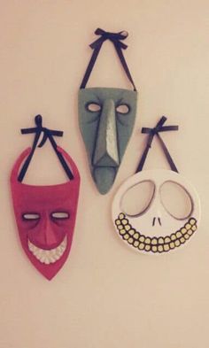 three masks are hanging on the wall