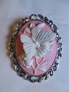 "It has a beautiful Large pink & white butterfly Cameo.The brooch is 2\" ( 5 cm) in length and on the back you have a silver tone brooch clasp. Combined shipping on multiple items." White Cameo Brooches For Formal Occasion, White Cameo Brooch For Formal Occasions, Victorian Style White Cameo Brooches, Victorian Style White Cameo Brooch, White Cameo Brooches For Wedding, White Cameo Brooch For Wedding, White Cameo Wedding Brooches, Victorian Pink Brooches For Wedding, Elegant Pink Brooches For Collectors