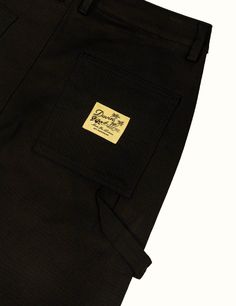 Our workwear pant in a loose fit, constructed of cotton with a little bit of stretch for added comfort. These pants have a longer Front Rise than normal so the Inseam starts a little lower than average All heights can comfortably wear the 30'' Inseam due to a scaling up Front Rise 98% Cotton / 2% Elastane Spandex Loose Fit Pre-Shrunk Pre-washed and will continue to get softer with future washes Back pocket woven label Wash cold with similar colors, dry on delicate setting Fits Loose In Hips / Le Black Cotton Work Pants With Patch Pockets, Urban Cotton Work Pants With Patch Pockets, Streetwear Cotton Bottoms With Welt Pockets, Black Utility Pants With Welt Pockets, Streetwear Chinos With Hip Pockets, Tapered Leg, Relaxed Fit Cotton Work Pants With Belt Loops, Streetwear Chinos With Tapered Leg, Baggy Black Cotton Work Pants, Black Cotton Work Pants With Cargo Pockets