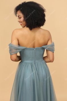 the back of a woman wearing a blue dress