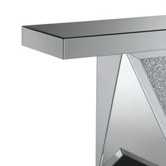 a silver table with glitter on it and a triangle shaped mirror over the top that is reflecting light