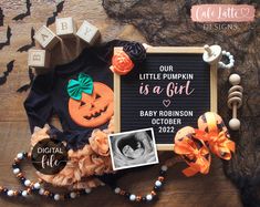 an image of a baby announcement with pumpkins and other items on the wood floor