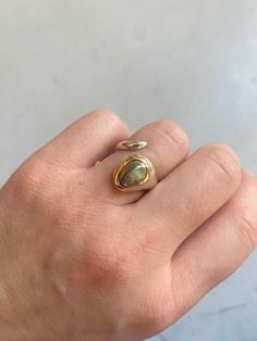 Snake silver and pearl ring with a beautiful pearl  Material: Sterling silver and 18K gold  Stones: pearl  Size: adjustable  Please try to be the most accurate about the size of your ring. o  If you do not know your ring size please check this method as well  o https://www.instagram.com/p/CTmHVMkATEg/ Don't hesitate to check my Instagram as well: @atelier_tiuh Follow the link below to go back to my Etsy SHOP: https://www.etsy.com/fr/shop/AtelierTiuh Gold Sterling Silver Moonstone Ring, Gold Open Ring Opal Fine Jewelry, Yellow Gold Open Pearl Ring, Gold Sterling Silver Opal Ring With Polished Finish, Yellow Gold Opal Open Ring, Unique Gold Moonstone Open Ring, Unique Gold Moonstone Ring With Open Design, Unique Gold Oval Pearl Ring, Silver And Gold Ring