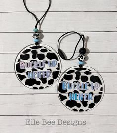 two black and white ornaments with the words bead up after being attached to them