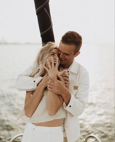 a man and woman embracing each other on a boat