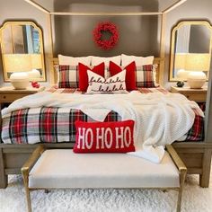 a bed with red and white pillows on it