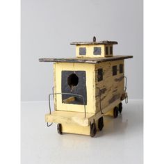 an old yellow toy train car with a hole in the roof