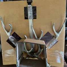 a cardboard box with antlers attached to it