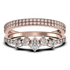 three stone diamond ring set in rose gold with diamonds on the band and side stones