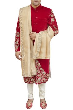 Red sherwani with placement hand floral work.
Components: 1
Neckline: Mandarin collar
Sleeve Length: Full sleeves
Fabric: Silk
Color: Red
Zardozi embroidery
Closure: Front buttons
Note: The churidar and stole  worn by the model are not for sale. - Aza Fashions Embroidered Anarkali Sherwani For Reception, Anarkali Sherwani With Resham Embroidery In Dola Silk, Traditional Drape Sherwani With Dabka Work In Dola Silk, Bollywood Style Embroidered Dola Silk Sherwani, Unstitched Dola Silk Sherwani For Festive Occasions, Designer Dola Silk Sherwani With Traditional Drape, Anarkali Style Sherwani With Resham Embroidery In Art Silk, Anarkali Style Sherwani With Zari Work, Semi-stitched Embroidered Anarkali Sherwani