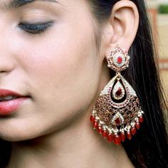 An oversized pair of earrings in gold plated silver set with freshwater pearls and ruby look alike synthetic red stones. Weight - 47 GMs Height - 9 cm Width- 4.5 cm 22k Gold Jewelry Necklaces, 22k Gold Jewelry, Red Stones, Chandbali Earrings, Pearl Necklace Set, Gold Jewelry Necklace, Emerald Necklace, Earrings In Gold, Gold Bangle Bracelet