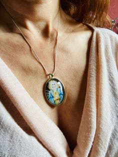 Beatiful pendant of Archangel Michael by Lily Moses. For more info please visit her website at: http://www.lilymoses.com/ and follow her on Instagram! The pendant is approx. 2,2 x1,6 inch (5,5 x 4 cm) and is set in a leadfree silver metal setting. The necklace is a very fine leadfree silver metal chain (length approx. 42cm). Due to the shape of the glass cabochon the light is reflected, so the real pendant is much more beautiful than the picture. The pendant is delivered in a nice velvet gift po Virgin Mary Pendant Jewelry As A Gift, Virgin Mary Pendant Jewelry Gift, Virgin Mary Pendant Necklace As Gift, Oval Virgin Mary Jewelry Gift, Michael Archangel, Photo Fails, Angel Jewelry, Angel Necklace, Saint Michael