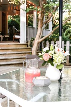 a table with flowers and a pitcher on it