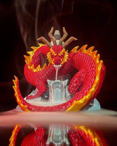 a red dragon statue sitting on top of a table