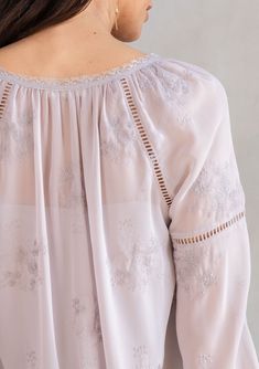 With a classic bohemian silhouette, this dreamy peasant top will be a timeless addition to your closet. Featuring delicate floral embroidery throughout, voluminous long sleeves with lattice trim, and a split v-neckline with tassel ties. We love to style this effortless blouse tucked into trousers or jeans. FINAL SALE Embroidered chiffon Relaxed fit Long voluminous sleeve Elastic wrist cuff Lace-trimmed neckline Split v-neckline with tassel ties Lattice trim throughout Sheer Removable lining Peas Feminine Long Sleeve Blouse For Gatherings, Flowy Peasant Top With Blouson Lantern Sleeves, Long Sleeve Bohemian Tops For Gatherings, Flowy Peasant Top With Blouson Sleeves, Long Sleeve Swiss Dot Blouse For Spring, Spring Long Sleeve Blouse With Swiss Dot, Embroidered Long Sleeve Tops For Daywear, Long Sleeve Peasant Top For Summer Gatherings, Bohemian Long Sleeve Blouse For Gatherings