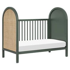 a green crib with a white mattress in the middle and an arched bed frame