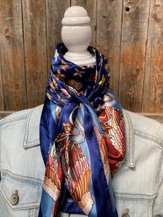 "Our classic wild rag/scarf in a blue color is accented with a multi-floral pattern. It is a square and measures 35\" x 35\". It is sure to add a bright pop of color to any outfit. Western or Crystal slides available to accent 100% machine washable polyester, silky and soft." Blue Silk Scarf As Gift, Blue Bandana Scarf As Gift, Blue Bandana As Gift, Blue Scarves For Spring, One Size, Blue One Size Scarves For Spring, One Size Blue Scarves For Spring, Bohemian Blue Bandana Scarf, Bohemian Blue Scarf Bandana, Blue Shawl Scarf For Gift