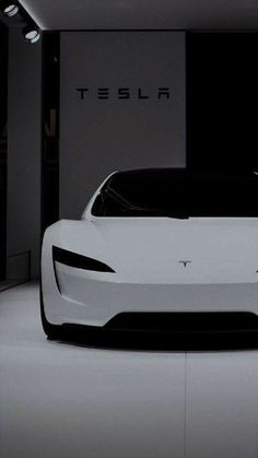 an electric car is shown in this black and white photo with the word tesla on it