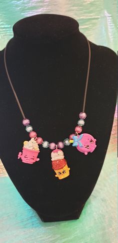 Stand out from the crowd with this statement necklace! :) Made from up-cycled Shopkins toys and beads hung on a 2mm thong with a silver lobster clasp. The length of the necklace is approx 36cms and the toys are 2cms in size. You will receive the exact item pictured.  Wear these out on adventures with you and add a pop of fun to any outfit :) Cute Multicolor Plastic Necklaces, Cute Handmade Plastic Necklace, Handmade Pink Plastic Necklace, Cute Adjustable Charms Necklaces, Playful Handmade Adjustable Charm Necklaces, Playful Adjustable Necklaces With Charms, Cute Adjustable Charm Necklaces, Cute Necklaces With Charms, Handmade Novelty Adjustable Necklace