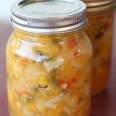 two jars filled with food sitting on top of a table