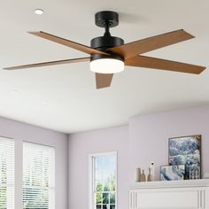 a living room with purple walls and a ceiling fan