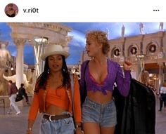 two women in short shorts and cowboy hats