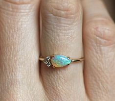 A delicate gorgeous genuine pear shaped Australian opal and white diamond cluster ring in 14k or 18k gold. The opal shines in a variety of colors (blue, white, pink, green ...). There's lots of fire! Perfect as an anniversary gift for her or as a multistone wedding band or a special engagement 4 stone ring. This unique and dainty four stone engagement or wedding ring is available in 14k and 18k solid rose, white, yellow gold or platinum. Please select the material from the drop-down menu on the Pear Opal Ring, Engagement Ring For Him, Opal Engagement Ring Set, Opal Band, Diamond Cluster Engagement Ring, Wedding Blue, Cluster Engagement Ring, Engagement Rings Opal, Diamond Gold