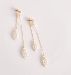 Our "Monique" earrings are created with petite cream crystal pearls hand weaved with gold wire to make delicate petal shapes One petal is attached to the butterfly back of the 14kt Gold filled stud earring and the other to the front giving it a unique look when worn - one petal drops in front of the ear and the other hangs from behind In the last image we paired it with our "Vera" comb which coordinates beautifully together Available in gold only Length is 3 1/4 inches (please let us know at che Modern Wedding Jewelry, Pearl Drop Earrings Bridal, Canadian Jewelry, Headpiece Jewelry, Pearl Earrings Wedding, Pearl Jewelry Wedding, Bridal Earrings Pearl, Pearl Cream, Modern Bridal