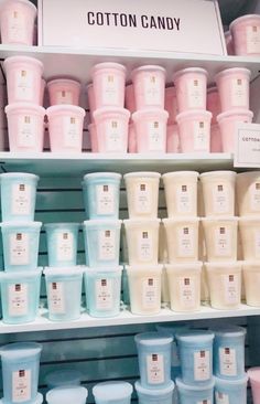 the shelves are filled with many different types of cotton candy cups and containers, all in pastel colors