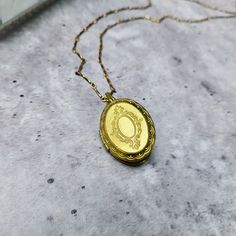 "** Orders placed after December 1, 2023 are not guaranteed for Christmas delivery domestic and international shipping is currently experiencing delays, so if you need your item by a certain date, please message prior to purchasing! ** The \"Jane\" gold brass locket necklace is comprised of a vintage oval locket from the 1970s, hung from a textured, vintage brass bar chain. Victorian-inspired filigree forms a 'frame' on the front face. You can select to personalize with images, or also write a message on a strip of paper and fold it to keep it inside the locket! + locket is vintage brass stock, size of 25mm x 20mm + locket has inserts on both left and right side + textured chain is antiqued brass, 16in long + polishing cloth included to maintain shine + made in Texas This locket necklace i Elegant Engraved Locket Necklace For Mom, Elegant Engraved Locket Necklace As Gift For Mom, Elegant Engraved Locket Necklace Gift For Mom, Gold Oval Pendant Locket Necklace For Personalized Gift, Gold Oval Locket Necklace For Personalized Gift, Oval Gold Locket Necklace For Personalized Gift, Round Locket Necklace For Mom, Heirloom Gold Locket Necklace Gift, Classic Gold Locket Necklace For Gift