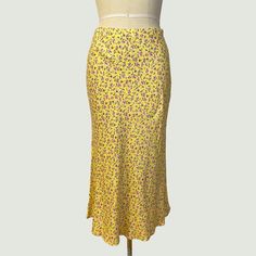 New With Tags. Perfect Skirt For The Warmer Weather. Yellow Midi Skirt With Purple And White Floral Print. Elastic Waistband. Measurements (Garment Laying Flat): Waist - 14" Hips - 20" Bottom Opening - 32" (Relaxed) Length - 33" Fabric Content: 100% Polyester Care Label Instructions: Dry Clean Or Hand Wash Cold. Please Note That: Dogs In Home; Smoke-Free Home; Measurements Are Approximate; We Use/Reuse Recycled Packaging When Possible; And Product Color May Vary Slightly Due To Photographic Ligh Yellow Skirted Bottoms For Summer, Yellow Stretch Maxi Skirt For Spring, Yellow Pleated Skirt For Spring, Yellow Floral Print Maxi Skirt For Spring, Yellow Relaxed Fit Maxi Skirt For Spring, Yellow Skirted Bottoms For Spring, Casual Yellow Maxi Skirt For Summer, Flowy Yellow Maxi Skirt For Spring, Yellow Long Skirt For Summer