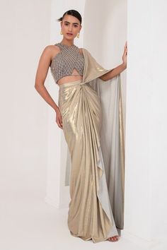 Grey and gold toned pre-draped saree crafted in metallic georgette. Paired with a sleeveless halter neck blouse with tonal crystal tassel and cutdana embellishments. - Aza Fashions Saree Styles Modern Party, Fitted Gold Pre-draped Saree For Festive Occasions, Gold Pre-draped Saree For Diwali Reception, Gold Pre-draped Saree For Reception And Festive Occasions, Gold Fitted Pre-draped Saree For Reception, Designer Gold Pre-draped Saree Floor-length, Gold Floor-length Designer Pre-draped Saree, Glamorous Gold Blouse Piece For Designer Wear, Glamorous Gold Saree For Designer Wear