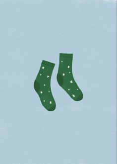 two pairs of green socks with stars on them against a light blue background, one pair is above the other