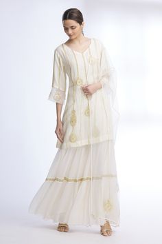 Off white kurta with floral embroidered motifs and stripes detail. Paired with sharara and sheer dupatta.
Components: 3
Fabric: Pure Silk Chanderi, Chiffon, Organza
Neckline: V neck
Sleeve Length: Three quarter
Color: White
Embroidered
Floral motif work
Sheer dupatta
Tiered sharara
Bead and pearl work
Flared sleeves - Aza Fashions Transitional Off-white Sets With Floral Embroidery, Wedding Sharara With Straight Kurta And Floral Embroidery, Wedding Sharara With Floral Embroidery And Straight Kurta, Festive Off White Palazzo Set With Intricate Embroidery, Festive Off-white Palazzo Set With Intricate Embroidery, Designer Floral Embroidered Sharara For Transitional Season, Designer Floral Embroidery Sharara For Transitional Season, Off White Floral Embroidered Sharara For Reception, Elegant Sharara With Floral Embroidery And Straight Kurta