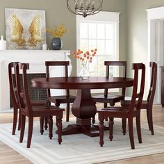 a dining room table with six chairs around it