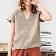 Introducing our Women's Cotton and Linen V-neck T-Shirt, a must-have for those who appreciate casual simplicity and effortless style. Crafted from a soft cotton-linen blend, this top offers a breathable and comfortable fit, perfect for any casual occasion. The solid color and V-neck design create a versatile piece that pairs beautifully with any outfit. Key Features: Soft Cotton-Linen Blend: Provides breathability and comfort for all-day wear. V-Neck Design: Adds a touch of elegance to a classic, casual look. Loose Fit: Ensures ease of movement and a relaxed silhouette. Solid Color: Versatile and easy to pair with various outfits. Casual Simplicity: Perfect for everyday wear, from relaxed weekends to casual outings. This Women's Cotton and Linen V-neck T-Shirt is your go-to for a comfortab Women Fall Tops, Linen Tops, Suede Fringe Jacket, Linen Clothing, Clothing Casual, Sleeve Women, Simple Shirts, Coats Jackets Women, Top For Women