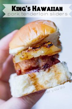 a hand holding a grilled cheeseburger with pineapple on the top and side