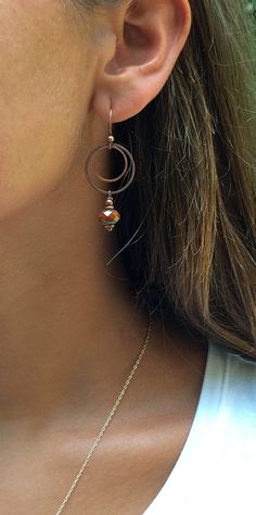 "Burnt orange dangle earrings with antiqued copper. Small, light-weight copper and Czech glass earrings that are perfect for your fall jewelry collection! The Czech glass is a beautiful, rustic, faceted burnt orange focal piece that dangle from two small antiqued copper rings. Product overview: - Made with Czech glass and antiqued copper - Total hanging length is 2\", the largest ring is the diameter of a penny - Small, versatile and light-weight - Hypoallergenic ear wires (lead and nickel free) Rust Color Dangle Earrings With Ear Wire, Rust Dangle Earrings With Ear Wire, Brown Copper Drop Earrings, Nickel-free Rust Drop Earrings, Vintage Rust-colored Nickel-free Earrings, Bronze Copper Hoop Earrings, Rust Copper Dangle Earrings, Brown Metal Hoop Jewelry, Orange Copper Dangle Earrings