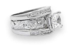 two wedding rings set with princess cut diamonds on each band and side stones in white gold