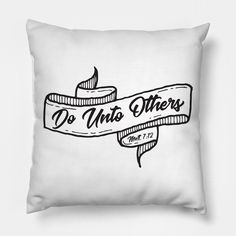 a black and white pillow with the words do unto others printed on it in cursive font