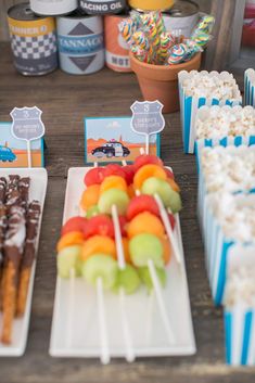 an assortment of desserts and snacks are on the table at a camper themed birthday party